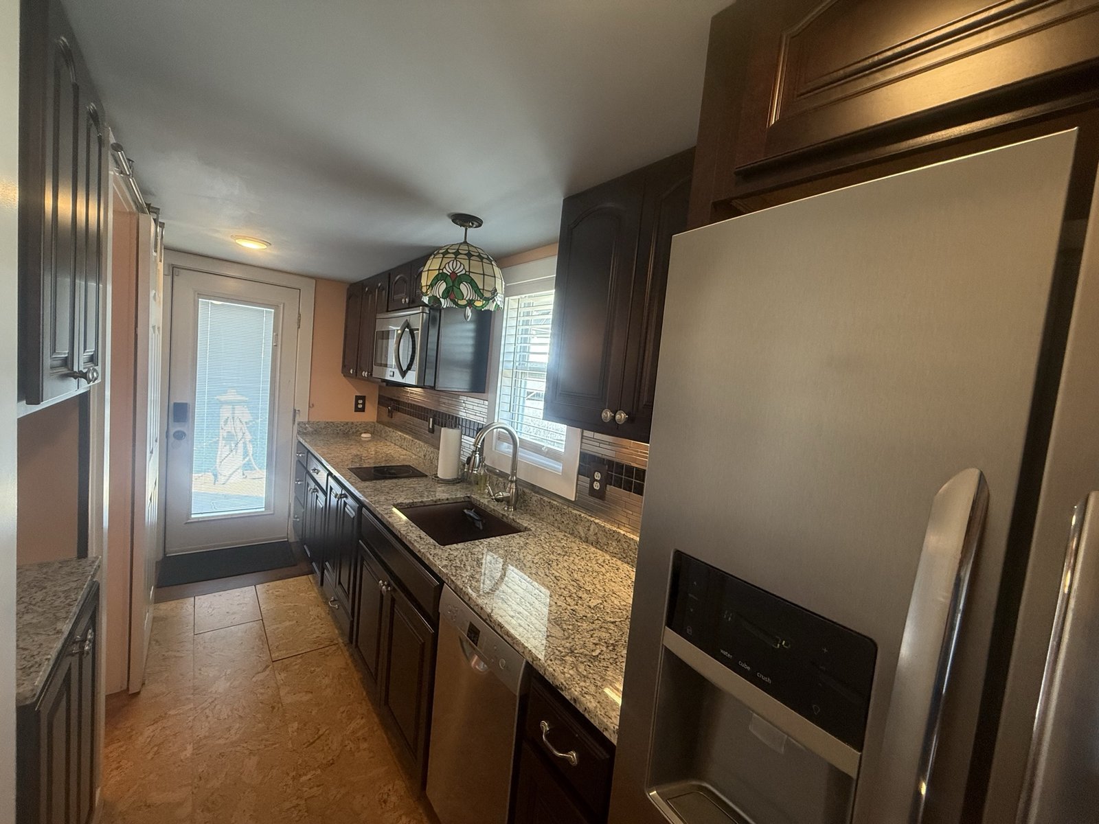 Full galley kitchen with granite counters and stainless appliances