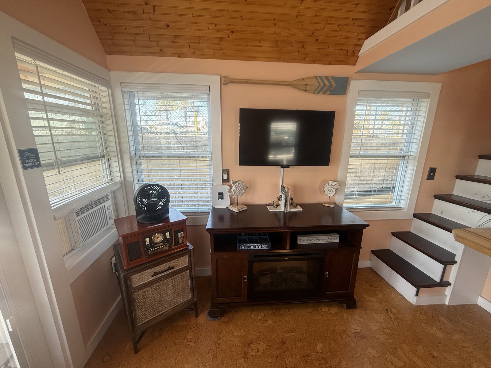 Living area with a smart TV and stairs up to the sleeping loft